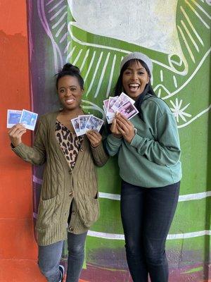 Happy guests with their Polaroid pictures after the  San Antonio Street Art Tour.