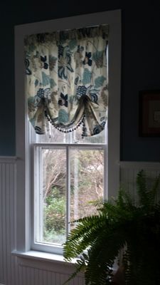 Tacked valance with trim on bottom edge