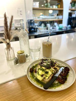 Iced sugar free vanilla oat milk latte and scrambled egg toast with mushrooms and herbs.