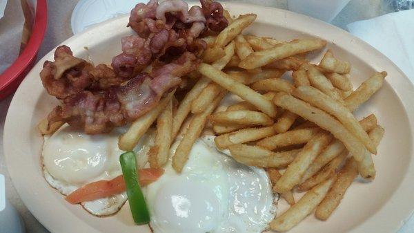 Breakfast with eggs, bacon, and fries. Also comes with cuban toast and cafe con leche.