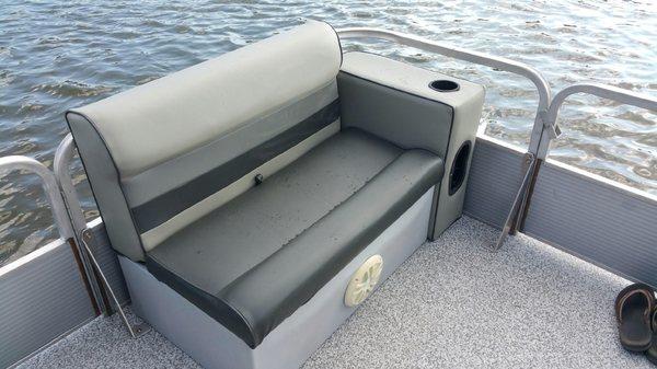 Pontoon boat with seats and consoles that was reupholstered.