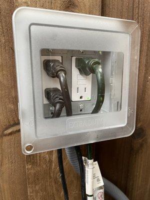 Our new waterproof outdoor plug box mounted up on the fence for easy access!