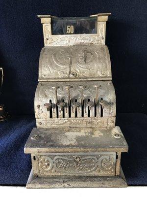 An older cash register from previous owners.