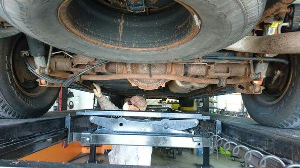 Doug inspecting surface rust under my 2002 Chevy Suburban.