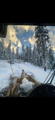 Construction site loader plowing with an amazing back drop