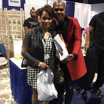 Lawrence of Real Housewives of Atlanta takes a photo at the Bronner Bros Show with Chuma Rose Beauty Supply owner.