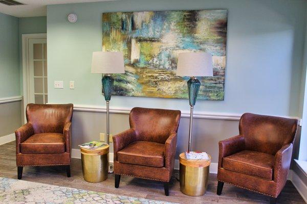 A bright, calm, friendly lobby in tranquil pale blues and greens. Comfortable homey brown leather chairs for clients and guests.