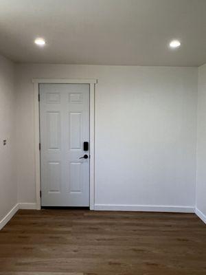 New Interior finished wall with paint, door trim and baseboard