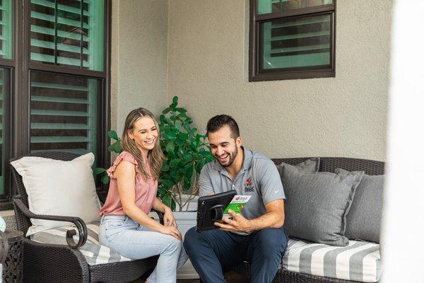 Sales representative discussing pest control options with homeowner.