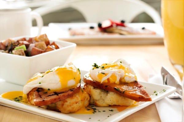 Eggs Benedict. Farm fresh eggs & sliced ham served on our homemade gluten free biscuits topped with hollandaise sauce.