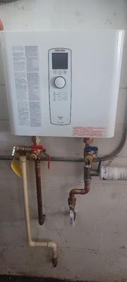 Replacement of a tank water heater with a STIBEL ELTRON TEMPRA PLUS TANKLESS WATER HEATER with isolation valves and pre-scale filter.