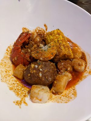 Boil plate with lobster tail and scallops.  Come also with corn and potatoes.  Spicy.