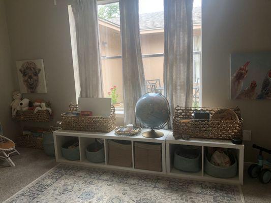 Another part of the playroom with shelves for younger children to be able to reach.