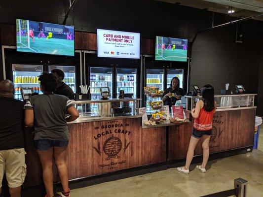 Storefront. Beer counter. Two registers. Located behind the Gullwing Club on Concourse 100. Sections 108C to 112C.