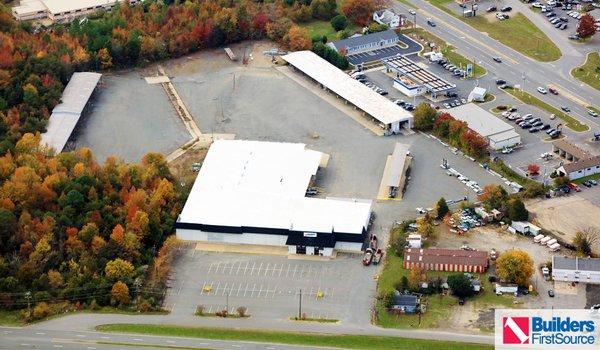 Building materials supplier Builders FirstSource's forklift is moving wood roof trusses.