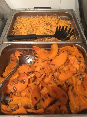 Sweet potatoes top with herbs and pumpkin seeds vegan meat casserole topped with cheddar cheese