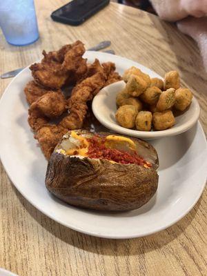 Chicken strips, loaded baked potato and okra.