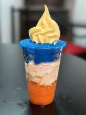 Large Gelatti customized with tangerine water ice, strawberry soft serve, blue razzberry water ice, and pineapple dole whip.