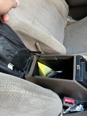 Center console raided, retention arms broken, items stolen.