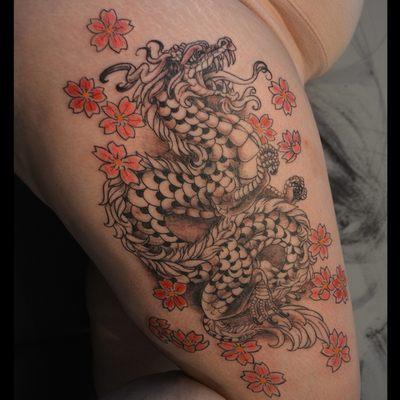 Cherry blossom dragon tattoo on the thigh