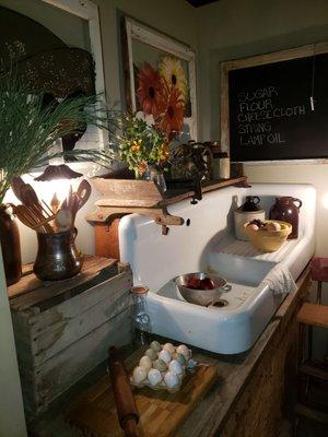 This vignette creates the perfect place for this gorgeous, antique, single bowl, right cornered sink base with built in drain board.