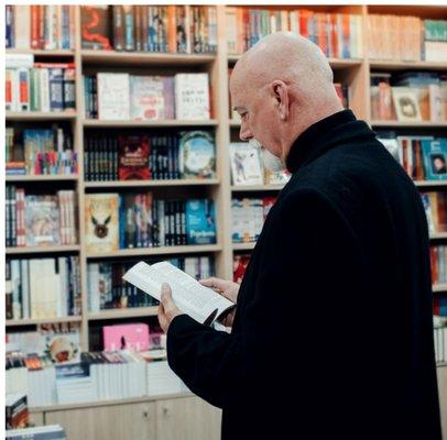 man reading in bookstore