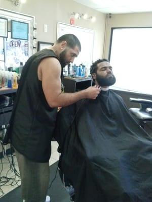 Luis working on a beard trim