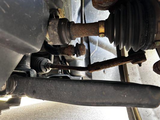 Picture of the bent tie rod looking toward the rear from the front of the front left wheel.