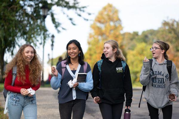 High School students walking to class on campus in the fall.