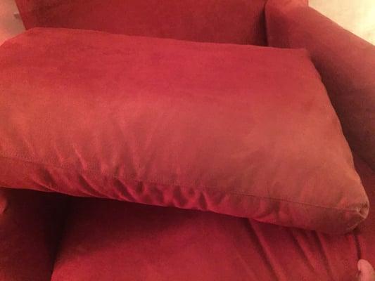 The bottom portion is clearly lighter than the top portion of the cushion.