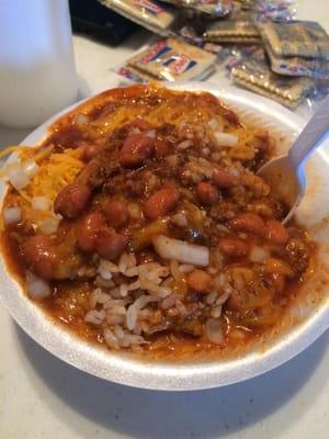 A small chili on rice with cheese and onions