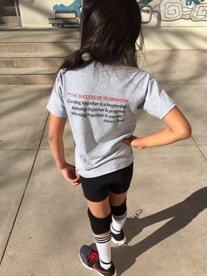 The Success of Teamwork quote on the back of her VB Synergy tee.