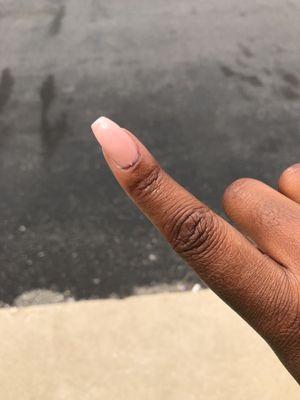 This nail is uneven and gel polish Is everywhere.