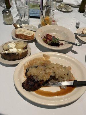 New York Strip with fried onions baked potato and side salad. It was very juicy and flavorful.