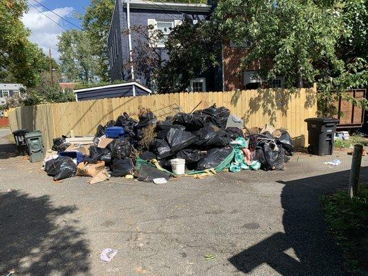 Garbage that piled up when Pronto Pro failed to remove construction debris from the alley (construction debris visible on bottom)