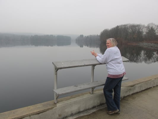 Scruffy person loitering by dam