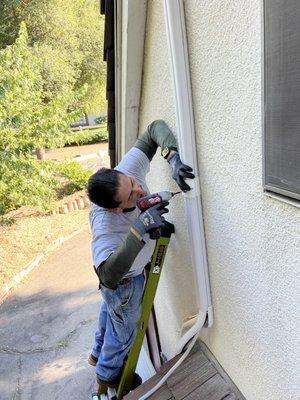 Installing the line set, communication wire and condensation hose.