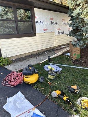 Vinyl siding being added to the house