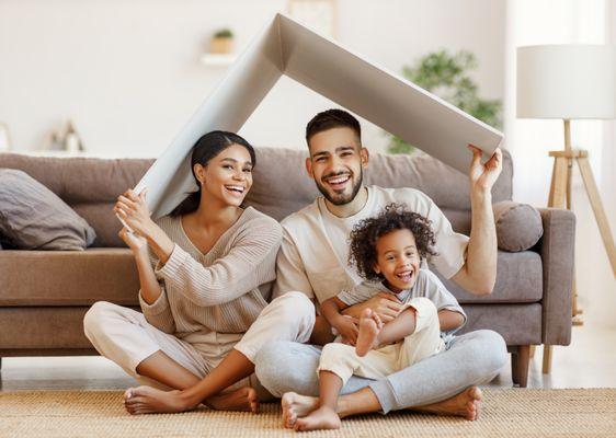 Young family celebrating their first day in their first house.