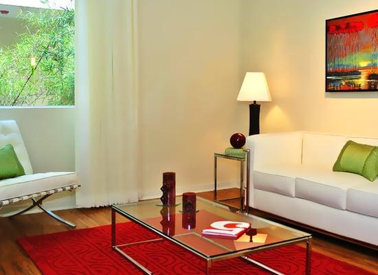 Model living room space with maple wooden floors.