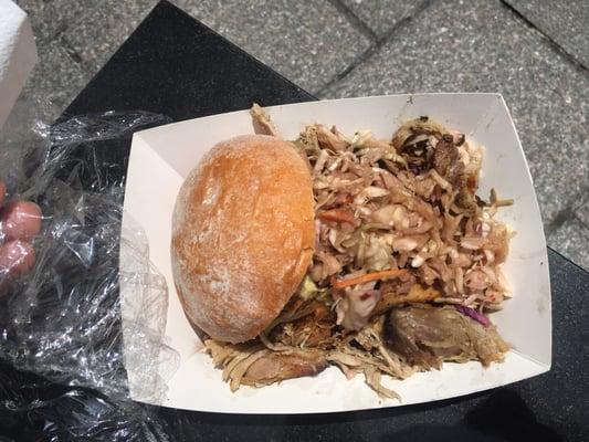 Pulled pork sandwich with spicy sauce and slaw