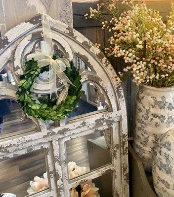 Oversized mirrors and preserves boxwood.