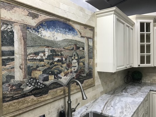 Fantasy Brown marble installed with cream color kitchen cabinets. Handmade mosaic tile install as backsplash.