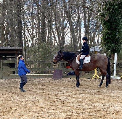 Instructor Dylan Philipps teaching a riding lesson to one of our regular students on lesson horse Thunder.