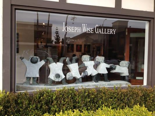 Sculpture in front window of gallery .