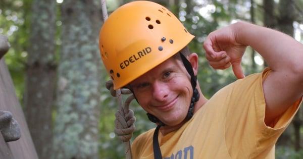 Happy camper climbing the wall at Camp Easter Seals UCP