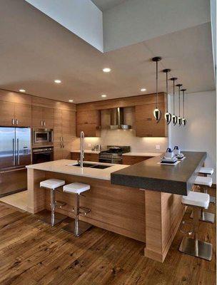 Beautiful kitchen lighting with the combination of recessed lights and pendant lights over the island set up on separate controls.