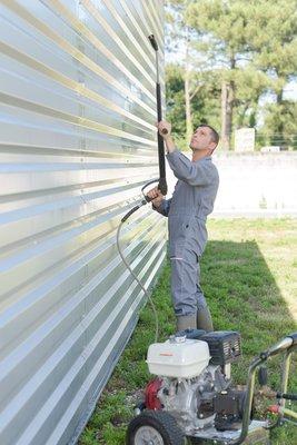 A power washing company in Alexandria Virginia using the soft washing technique to clean siding.