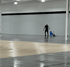 An employee using the Aztec Grand Finale Floor Solution Applicator at the new Dick's in Bel Air, MD