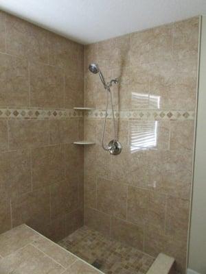 Shower with seat and corner shelves.